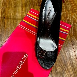 Silver open toll 2 1/2 inches heels with the little silver button on the front